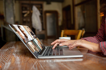 Image showing Remote working. Workplace in bar, restaurant office with PC, devices and gadgets.