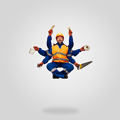 Image showing Handsome contractor, multi-armed builder levitating isolated on grey studio background