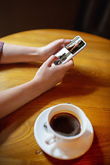 Image showing Remote working. Workplace in bar, restaurant office with PC, devices and gadgets.