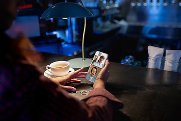 Image showing Remote working. Workplace in bar, restaurant office with PC, devices and gadgets.