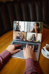 Image showing Remote working. Workplace in bar, restaurant office with PC, devices and gadgets.