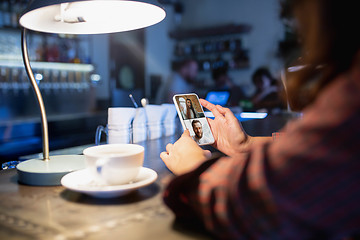 Image showing Remote working. Workplace in bar, restaurant office with PC, devices and gadgets.