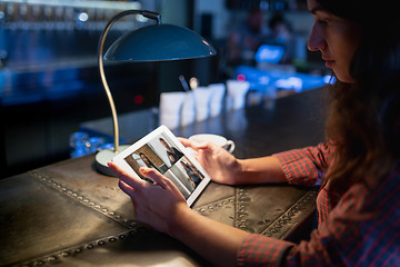 Image showing Remote working. Workplace in bar, restaurant office with PC, devices and gadgets.