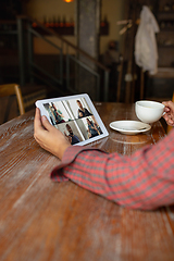 Image showing Remote working. Workplace in bar, restaurant office with PC, devices and gadgets.