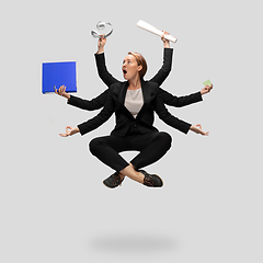 Image showing Beautiful business woman, secretary, multi-armed manager levitating isolated on grey studio background