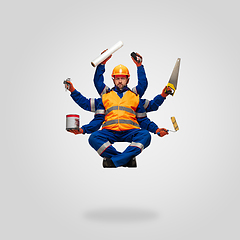 Image showing Handsome contractor, multi-armed builder levitating isolated on grey studio background