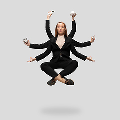 Image showing Beautiful business woman, secretary, multi-armed manager levitating isolated on grey studio background