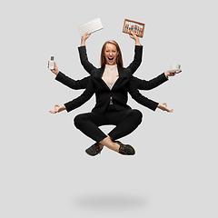 Image showing Beautiful business woman, secretary, multi-armed manager levitating isolated on grey studio background