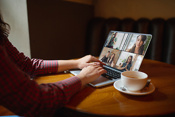 Image showing Remote working. Workplace in bar, restaurant office with PC, devices and gadgets.