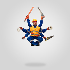 Image showing Handsome contractor, multi-armed builder levitating isolated on grey studio background