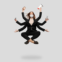 Image showing Beautiful business woman, secretary, multi-armed manager levitating isolated on grey studio background