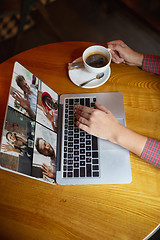 Image showing Remote working. Workplace in bar, restaurant office with PC, devices and gadgets.