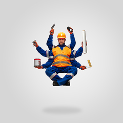 Image showing Handsome contractor, multi-armed builder levitating isolated on grey studio background