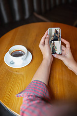 Image showing Remote working. Workplace in bar, restaurant office with PC, devices and gadgets.