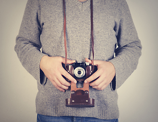 Image showing Man holiding retro camera