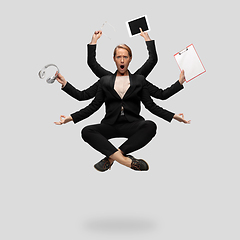 Image showing Beautiful business woman, secretary, multi-armed manager levitating isolated on grey studio background