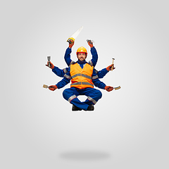 Image showing Handsome contractor, multi-armed builder levitating isolated on grey studio background