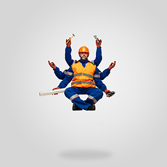 Image showing Handsome contractor, multi-armed builder levitating isolated on grey studio background