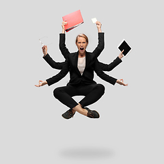 Image showing Beautiful business woman, secretary, multi-armed manager levitating isolated on grey studio background