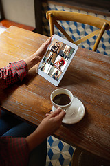 Image showing Remote working. Workplace in bar, restaurant office with PC, devices and gadgets.