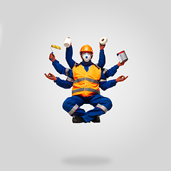 Image showing Handsome contractor, multi-armed builder levitating isolated on grey studio background