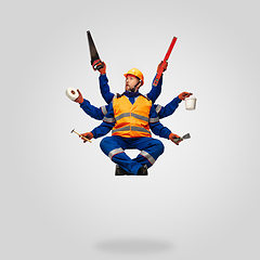 Image showing Handsome contractor, multi-armed builder levitating isolated on grey studio background