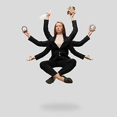 Image showing Beautiful business woman, secretary, multi-armed manager levitating isolated on grey studio background