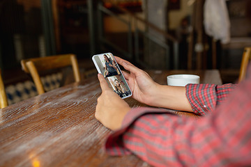 Image showing Remote working. Workplace in bar, restaurant office with PC, devices and gadgets.