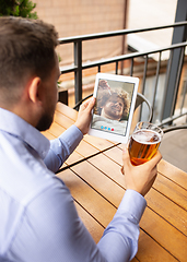 Image showing Remote working, online entertainment during quarantine. Remote events in bar, restaurant office with PC, devices and gadgets.