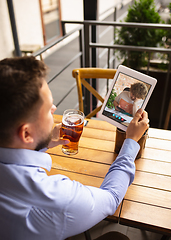 Image showing Remote working, online entertainment during quarantine. Remote events in bar, restaurant office with PC, devices and gadgets.