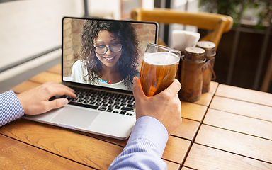 Image showing Remote working, online entertainment during quarantine. Remote events in bar, restaurant office with PC, devices and gadgets.