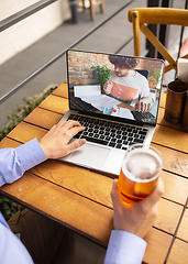 Image showing Remote working, online entertainment during quarantine. Remote events in bar, restaurant office with PC, devices and gadgets.