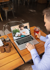 Image showing Remote working, online entertainment during quarantine. Remote events in bar, restaurant office with PC, devices and gadgets.