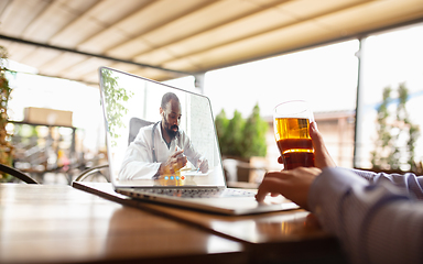 Image showing Remote working, online entertainment during quarantine. Remote events in bar, restaurant office with PC, devices and gadgets.