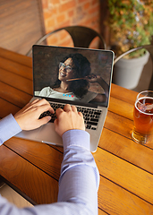 Image showing Remote working, online entertainment during quarantine. Remote events in bar, restaurant office with PC, devices and gadgets.