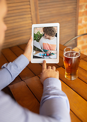 Image showing Remote working, online entertainment during quarantine. Remote events in bar, restaurant office with PC, devices and gadgets.