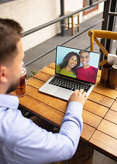 Image showing Remote working, online entertainment during quarantine. Remote events in bar, restaurant office with PC, devices and gadgets.