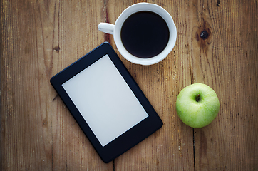 Image showing E-book reader and coffee