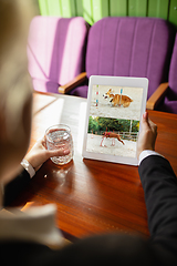 Image showing Remote working. Workplace in bar, restaurant office with PC, devices and gadgets.