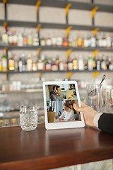 Image showing Remote working. Workplace in bar, restaurant office with PC, devices and gadgets.