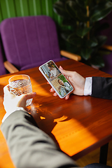 Image showing Remote working. Workplace in bar, restaurant office with PC, devices and gadgets.