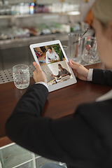 Image showing Remote working. Workplace in bar, restaurant office with PC, devices and gadgets.