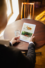 Image showing Remote working. Workplace in bar, restaurant office with PC, devices and gadgets.