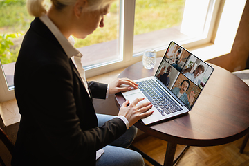 Image showing Remote working. Workplace in bar, restaurant office with PC, devices and gadgets.