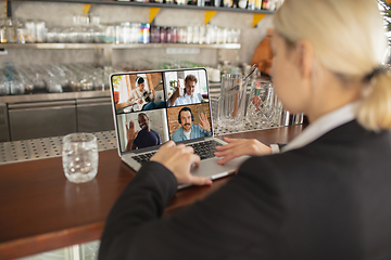 Image showing Remote working. Workplace in bar, restaurant office with PC, devices and gadgets.