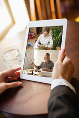 Image showing Remote working. Workplace in bar, restaurant office with PC, devices and gadgets.