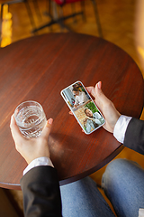 Image showing Remote working. Workplace in bar, restaurant office with PC, devices and gadgets.