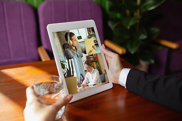 Image showing Remote working. Workplace in bar, restaurant office with PC, devices and gadgets.