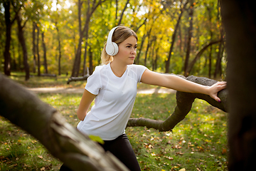 Image showing Disabled woman walking down and training outdoors in forest