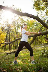 Image showing Disabled woman walking down and training outdoors in forest